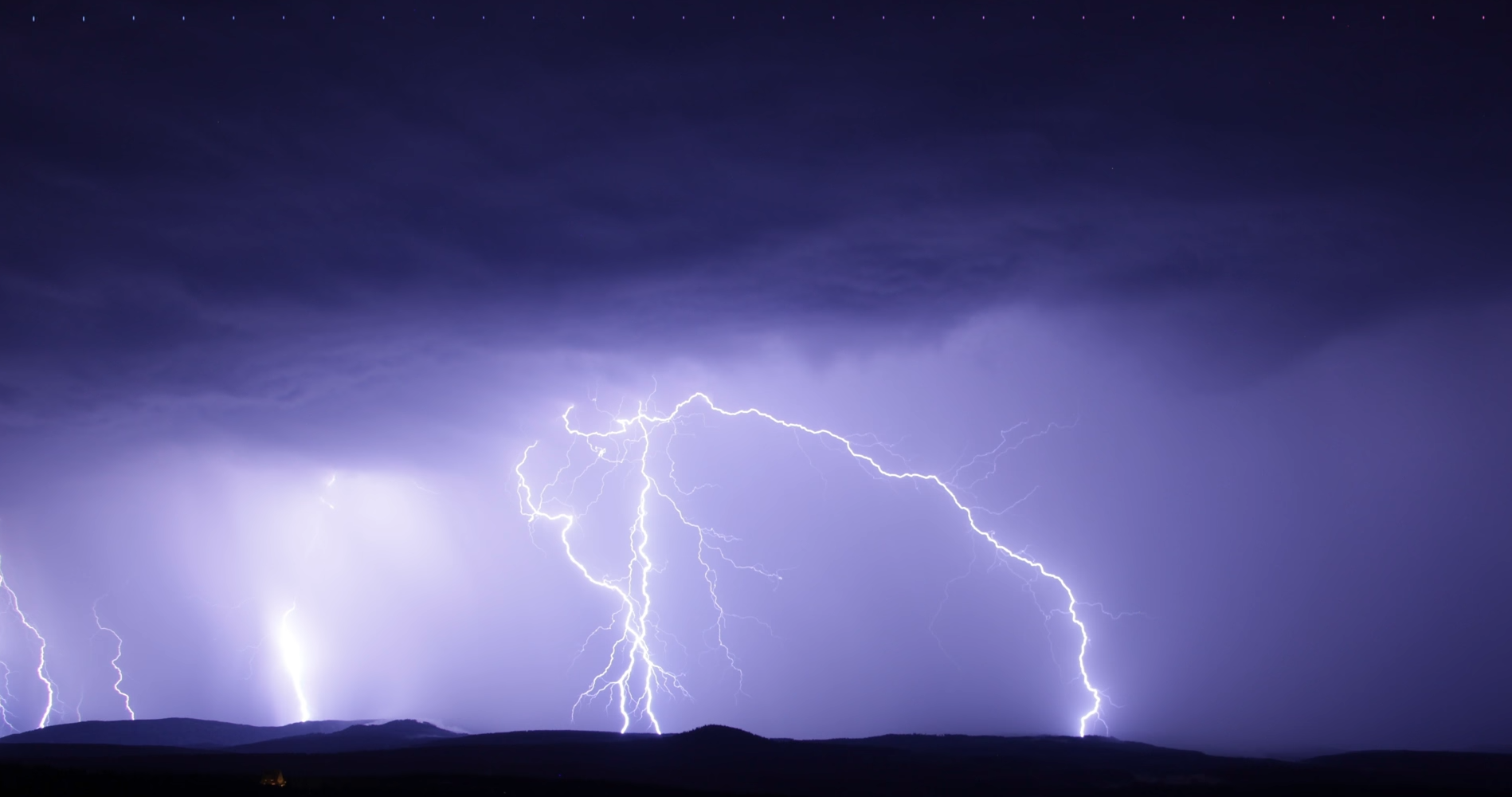 photography of heavy lighting in a purple sky, possibly at night